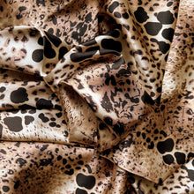 Load image into Gallery viewer, Satin material in a tan, brown and black in an African leopard animal print.