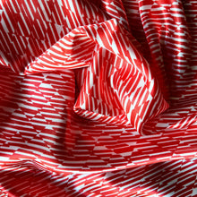 Load image into Gallery viewer, red and white satin pillowcase swirled to show the pattern.