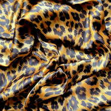 Load image into Gallery viewer, A swirled piece of satin material in a beautiful African leopard animal print in gold and black.