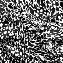 Load image into Gallery viewer, Black and white satin fabric displayed in a swirl.