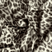 Load image into Gallery viewer, A view from above looking at swirled satin material in a beautiful gray and black leopard print.
