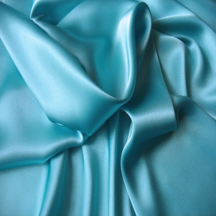 Satin material in a solid aquamarine color. The material is swirled.
