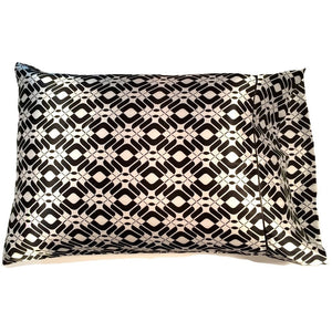 A sofa pillow with a black and white diamond shaped print pillow cover. The pillow measures 12 x 16".
