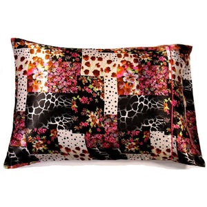 A throw pillow with a patchwork design that has animal prints and flowers on the cover. The pillow is 12" x 16".
