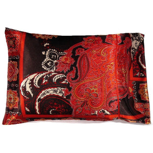 A travel pillow with a rust and orange paisley satin print cover. The pillow measures 12" x 16".