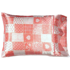 An accent pillow with a patchwork cover in pink and white. The pillow measures 12" x 16".