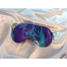 Load image into Gallery viewer, A beautiful turquoise blue and purple paisley print satin sleep mask laying on top of a white satin sheet.