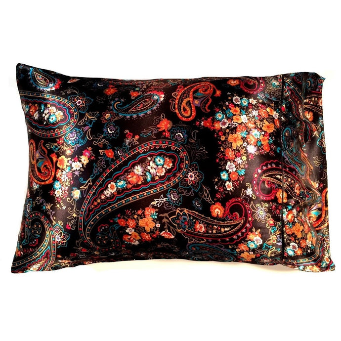 An accent pillow with a black satin cover that has a orange, white, turquoise blue and red paisley print. The pillow measures 12
