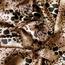 Load image into Gallery viewer, Satin material in a tan, brown and black in an African leopard animal print. 
