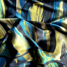 Load image into Gallery viewer, Black, turquoise bue, green and gold abstract print displayed in a swirl.
