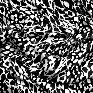 Black and white satin fabric displayed in a swirl.