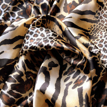 Load image into Gallery viewer, Brown, beige, black and gold cheetah and leopard print satin fabric. Twisted in a swirl to show the pattern.
