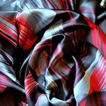 Load image into Gallery viewer, Red, black and gray satin fabric in an abstract modern print displayed in a swirl.
