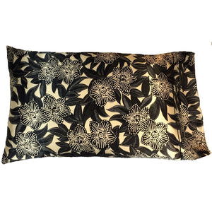 Satin pillowcase with black etched flowers and black leaves on an ivory satin background.