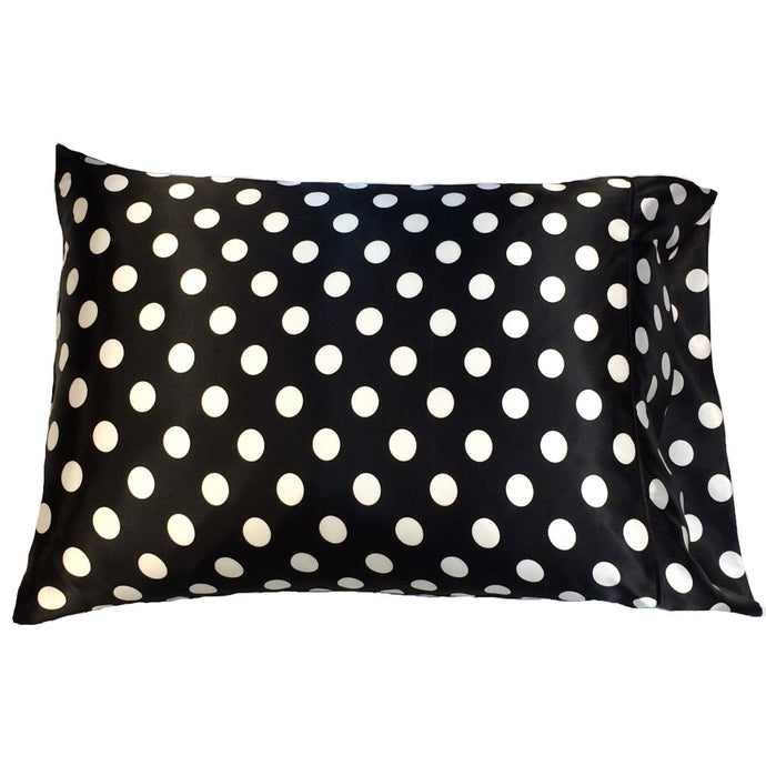 A black satin pillowcase with large white polka dots.