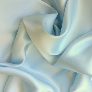 Satin material in solid powder blue. The material is swirled.
