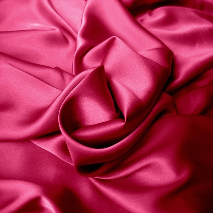 raspberry satin material that is swirled.