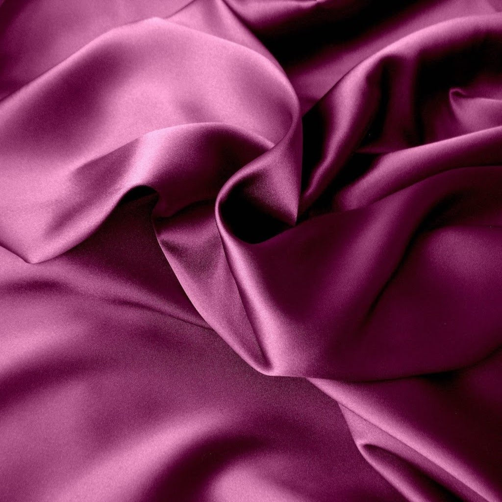 Violet colored satin material that is swirled.