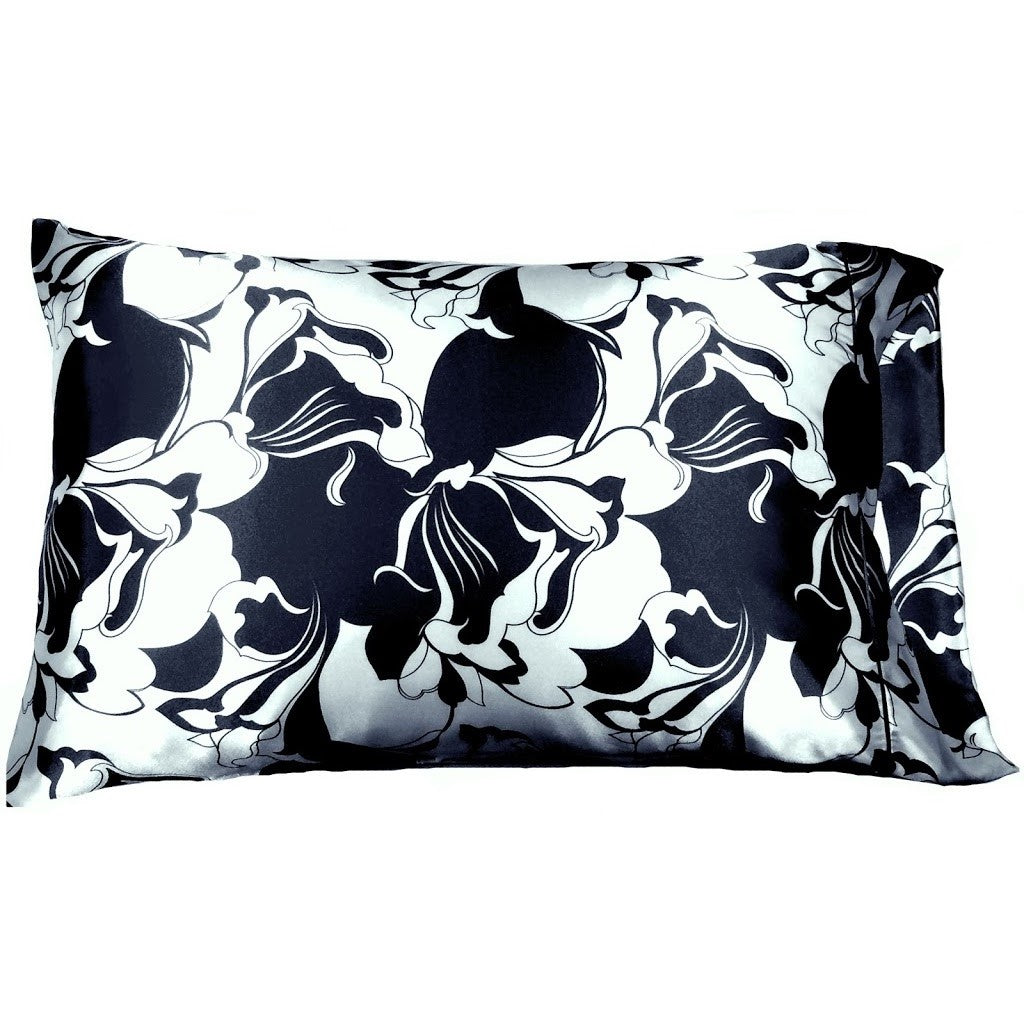 A navy blue and white satin pillowcase in a flowers print.