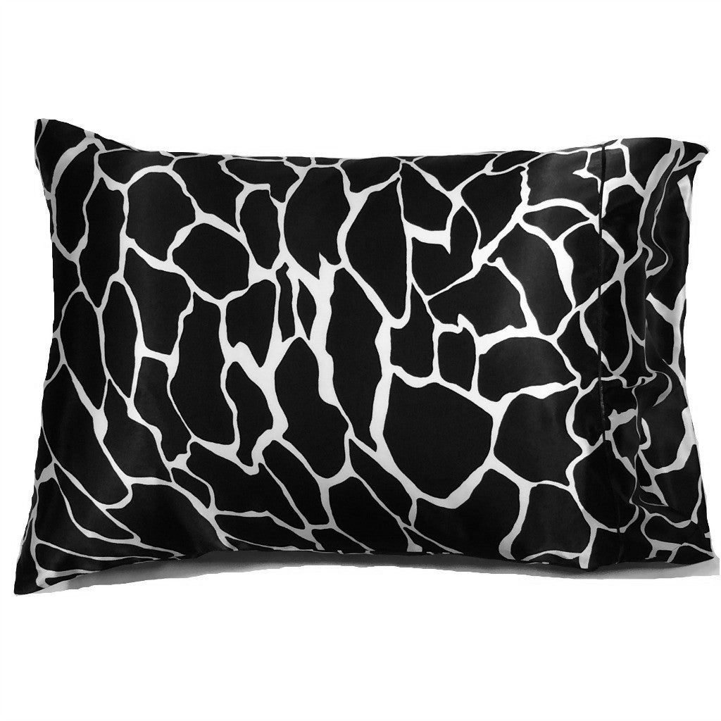 A black and white giraffe pattern satin pillowcase.