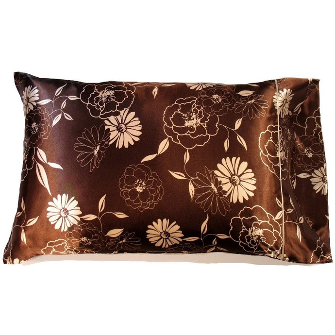 A brown satin pillowcase with white flowers and etched white flowers.