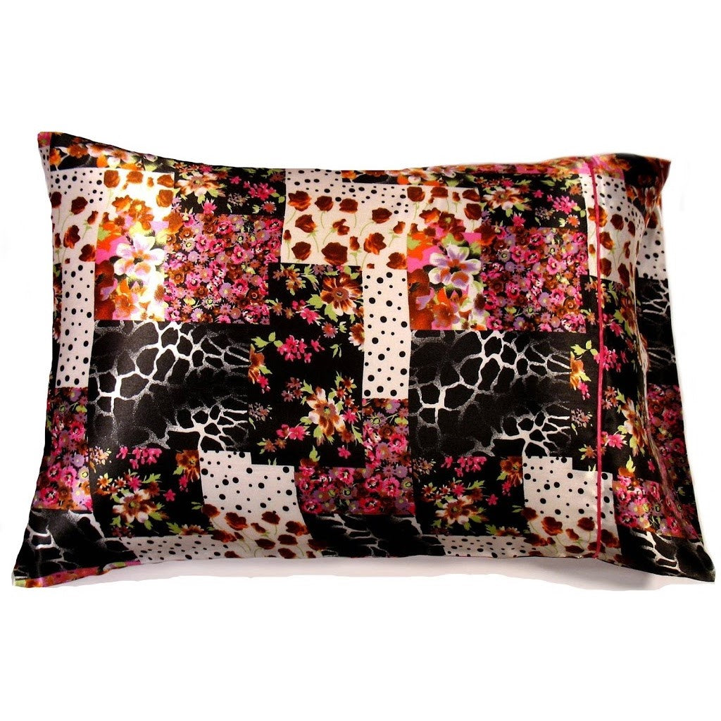 A satin pillowcase with pink and brown flowers along with a black and white giraffe print.