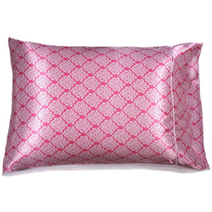 A pink satin pillowcase with a white triangular floral pattern.