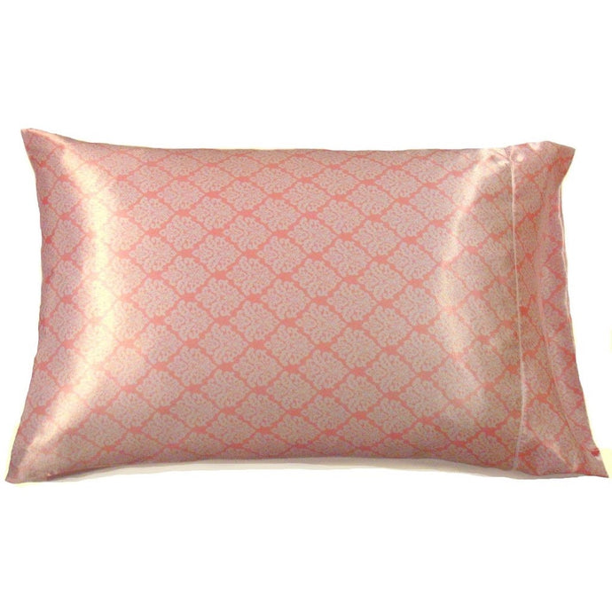 A satin pillowcase in a pink and white geometric print.