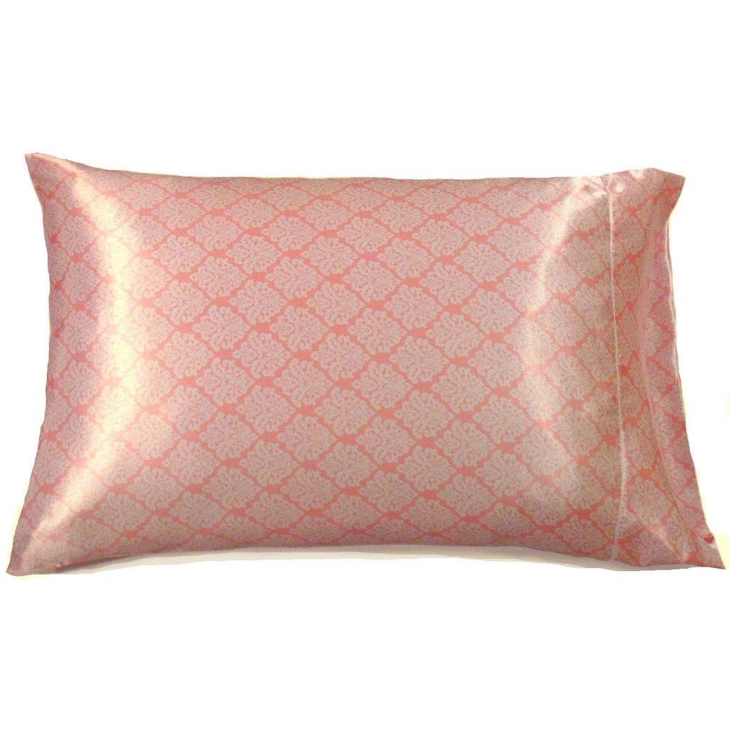A satin pillowcase in a pink and white geometric print.