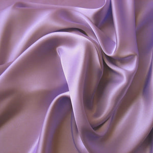 satin material in a solid lavender color. The material is swirled around.