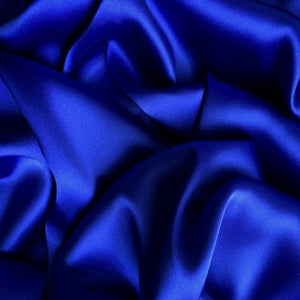 Satin material in a royal blue solid color. The material is swirled.