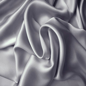 satin material in a solid platinum color. The material is swirled.
