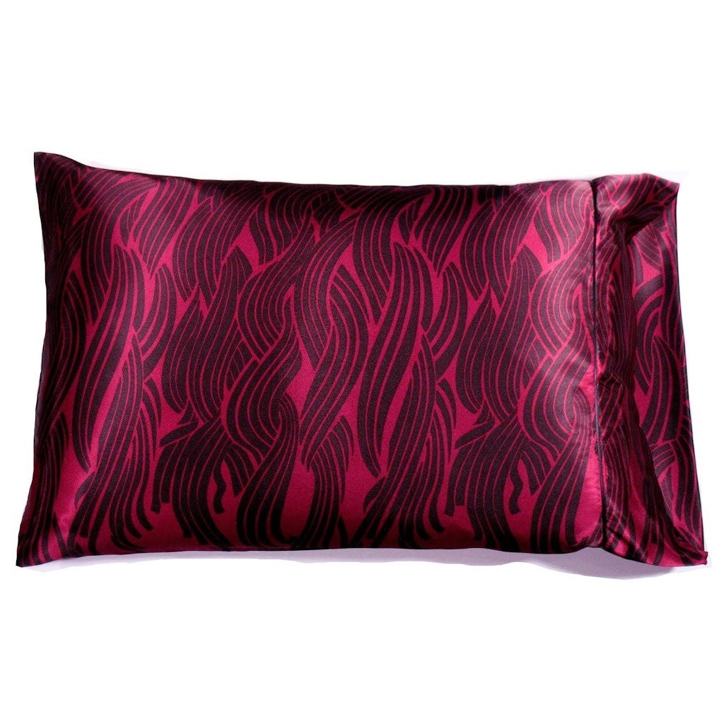 A magenta satin pillowcase with black vertical lines.