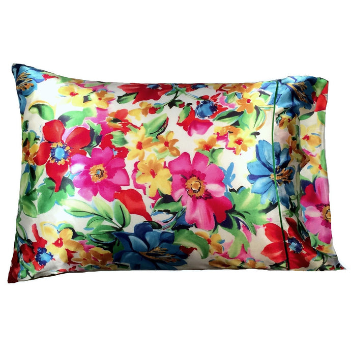 A satin pillow with pink, yellow, blue, red and green flowers on the cover. The pillow measures 12