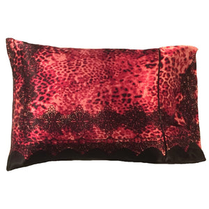 A decorative pillow with a rust colored cheetah print satin cover. The cover also has black lace along the bottom and up the sides. The pillow measures 12" x 16".