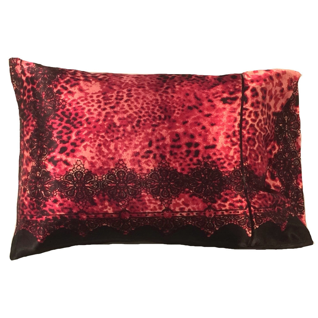 A decorative pillow with a rust colored cheetah print satin cover. The cover also has black lace along the bottom and up the sides. The pillow measures 12