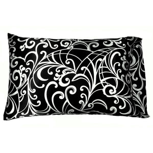 An accent pillow with a black satin cover that has white swirls on it. The pillow measures 12" x 16".