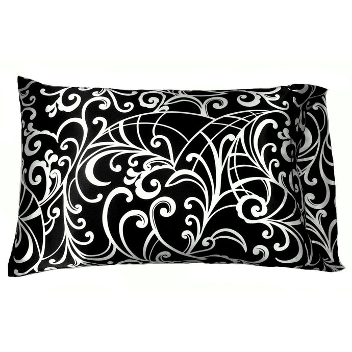 An accent pillow with a black satin cover that has white swirls on it. The pillow measures 12