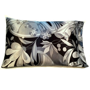 This decorative pillowcase is made from a black with gray flowers satin print. The pillow measures 12" x 16".