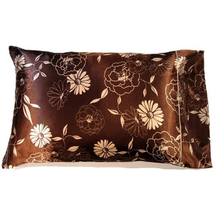 A toss pillow with a brown cover that has etched beige flowers and solid beige flowers on the cover. The pillow measures 12" x 16".
