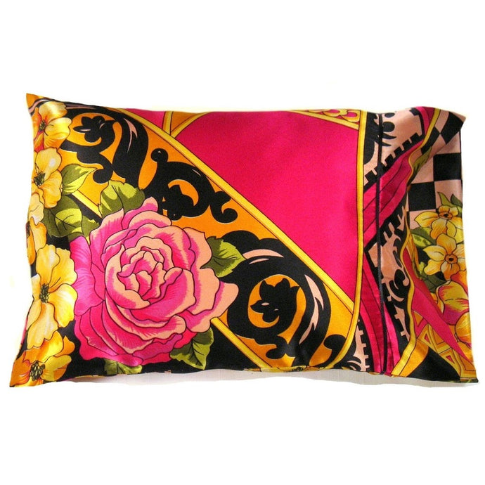A boudoir pillow with a pillow cover that has a pink rose, yellow flowers and some pink, yellow and black designs. It has a Boho style to it. The pillow is 12
