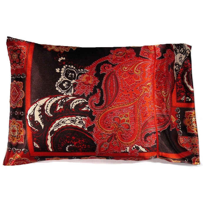 A travel pillow with a rust and orange paisley satin print cover. The pillow measures 12