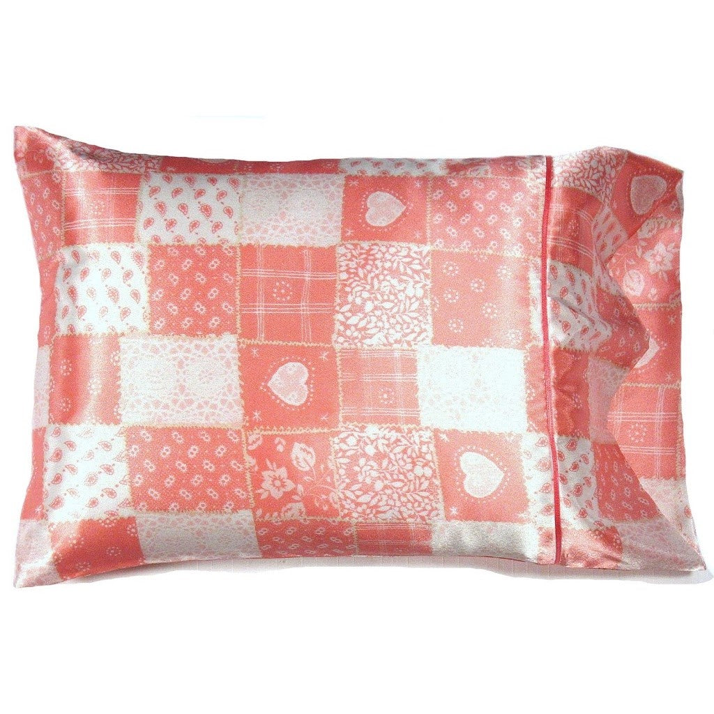 An accent pillow with a patchwork cover in pink and white. The pillow measures 12