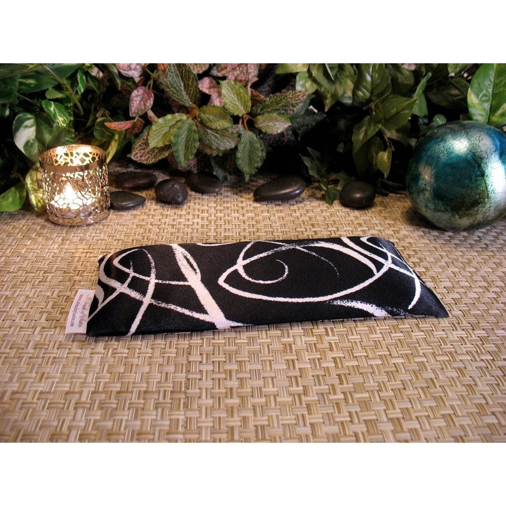 This scented eye pillow is made with a black and white satin print, filled with organic flaxseed for unscented or choose organic lavender or peppermint for scented.