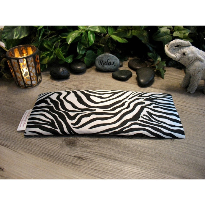 This aromatherapy eye pillow is made with a black and white zebra satin print, filled with organic flaxseed for unscented or choose organic lavender or peppermint for scented.
