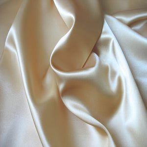 A look from above at champagne beige satin material  swirled. and twisted