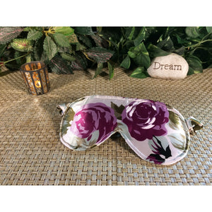 Green and plum floral print. eye mask with satin covered elastic strap. Eye shade blocks out light.