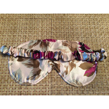 Load image into Gallery viewer, The back of a green and plum colored floral print eye mask showing the back with the satin covered strap
