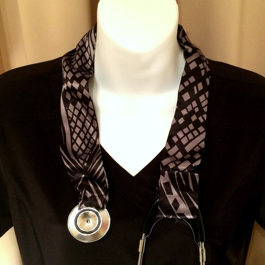 Our stethoscope cover is made from a black and taupe color charmeuse satin print and is washable. The cover has a Velcro closing to keep it in place.