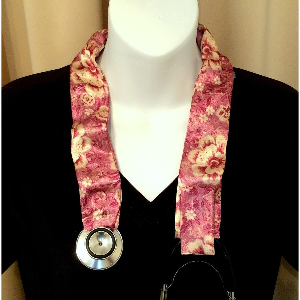 Our veterinarian stethoscope cover is made from a pink and cream flowers charmeuse satin print and is washable. The cover has a Velcro closing to keep it in place.